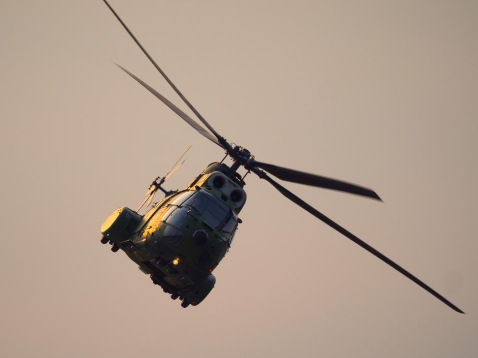 Free Image of A helicopter flying in the sky 
