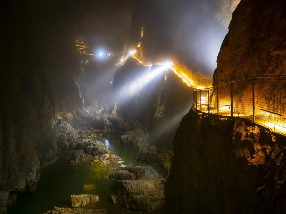 Free Image of A bridge over a rocky cliff with lights 