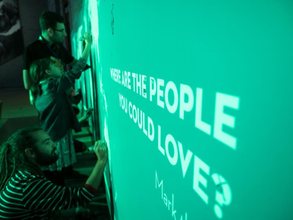 Free Image of A group of people writing on a wall 
