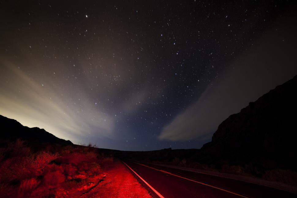 Free Image of A road with red lights at night 