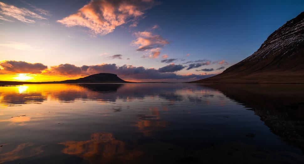 Free Image of A body of water with a hill in the distance 