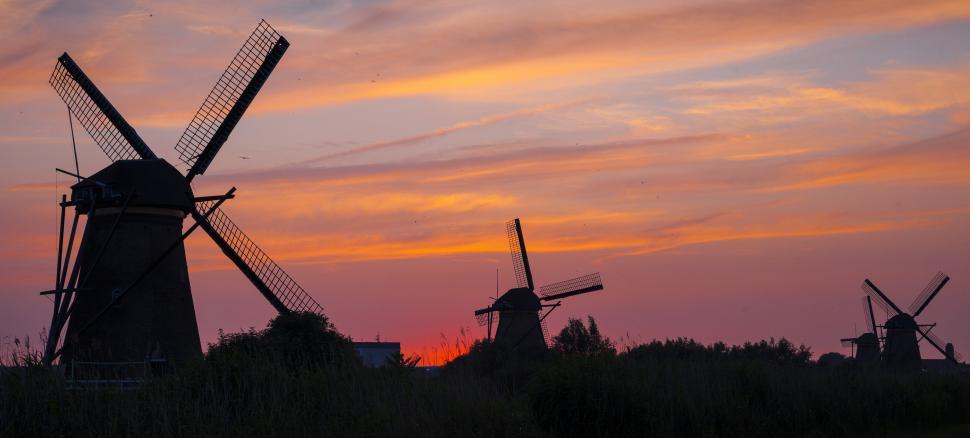 Free Image of Windmills in a field during sunset 