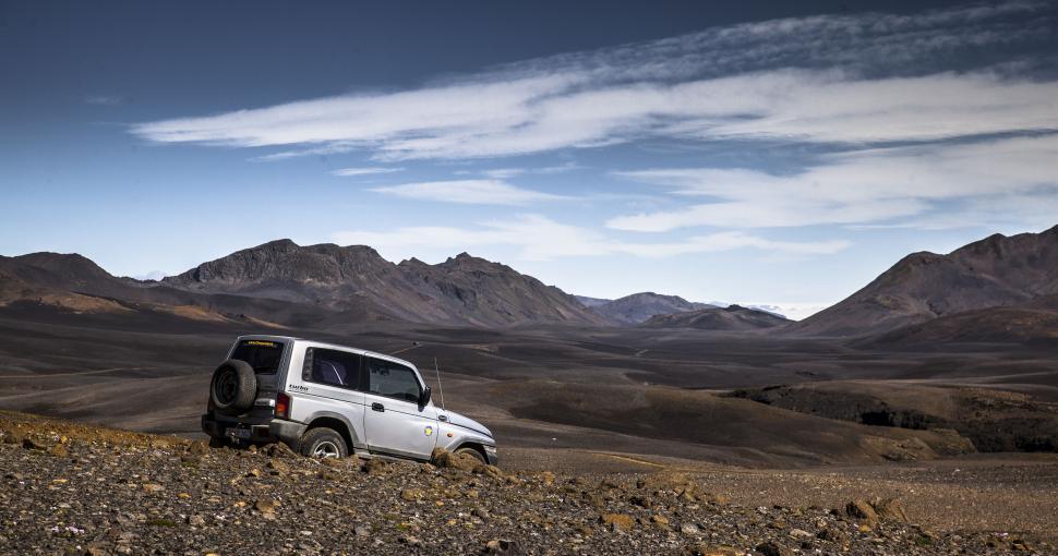 Free Image of A car parked in a dirt field 