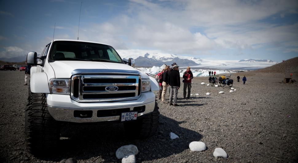 Free Image of A group of people standing in front of a truck 