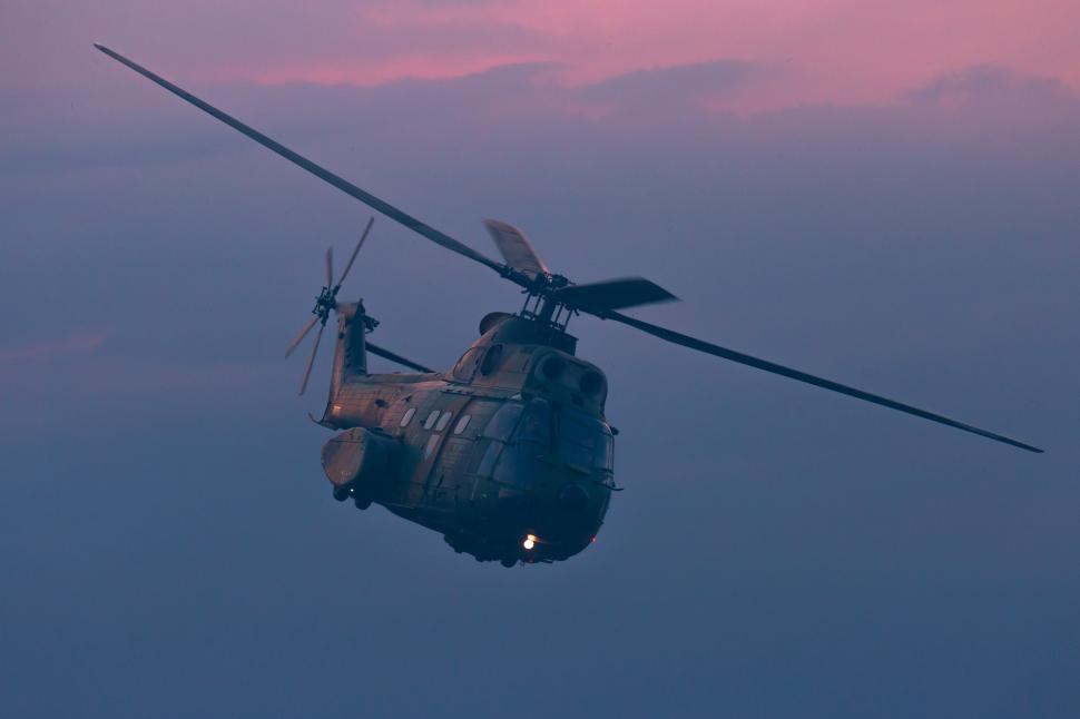 Free Image of A helicopter flying in the sky 