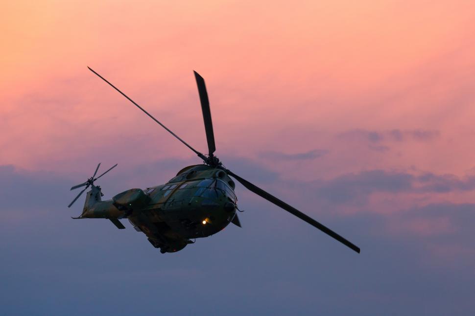 Free Image of A helicopter flying in the sky 