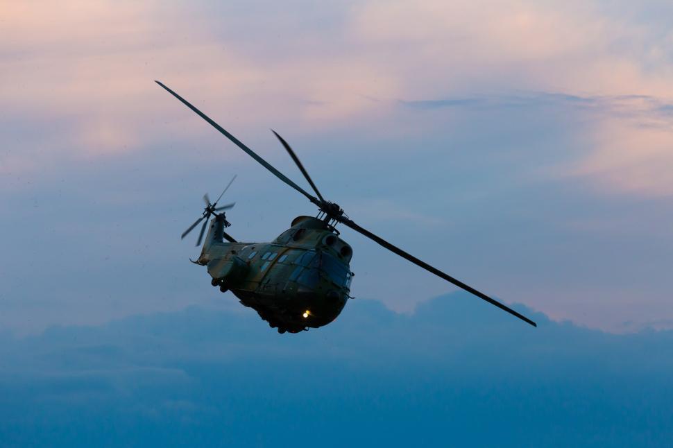 Free Image of A helicopter flying in the sky 