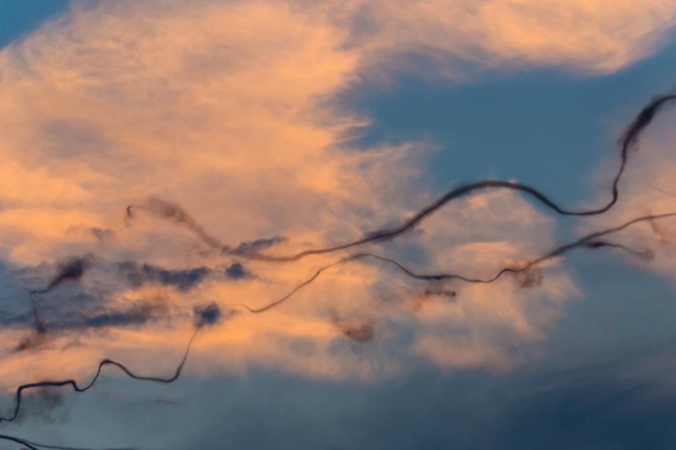 Free Image of A long thin trail of smoke in the sky 