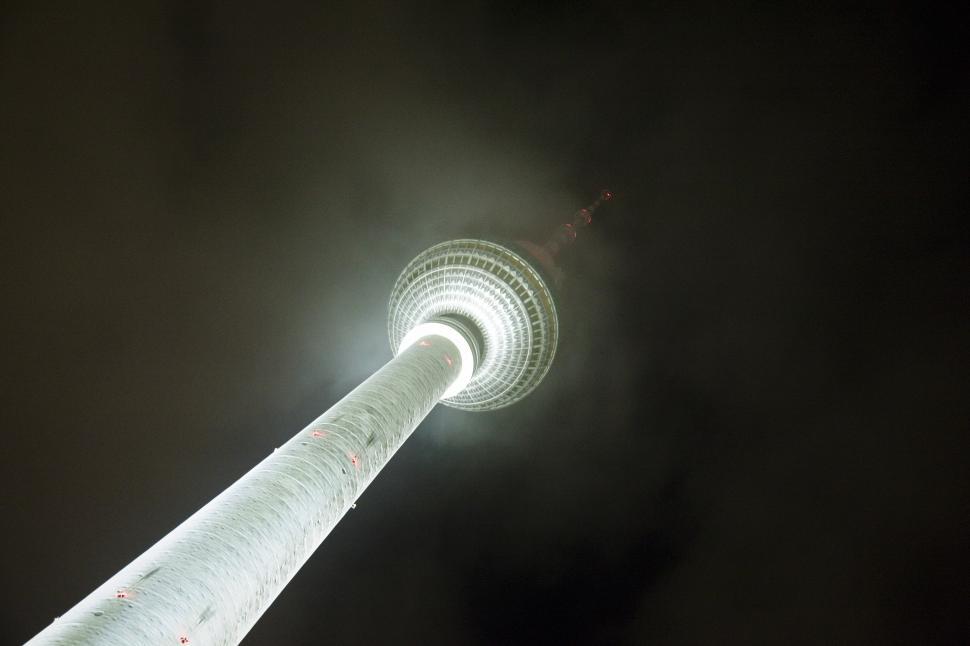 Free Image of A tall tower with a large round tower 