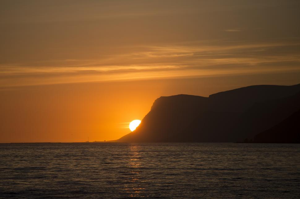 Free Image of A sunset over a body of water 