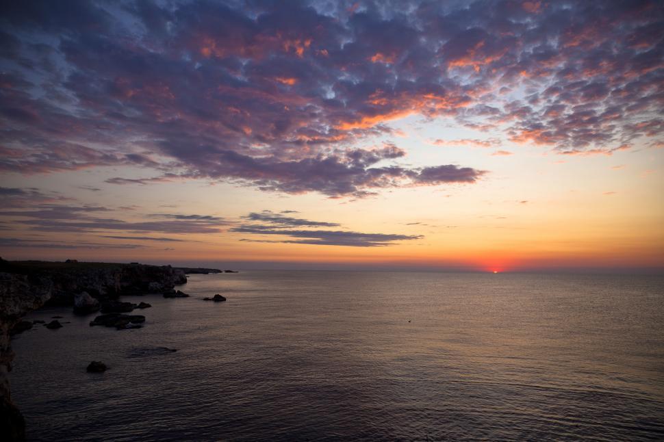 Free Image of A sunset over a body of water 