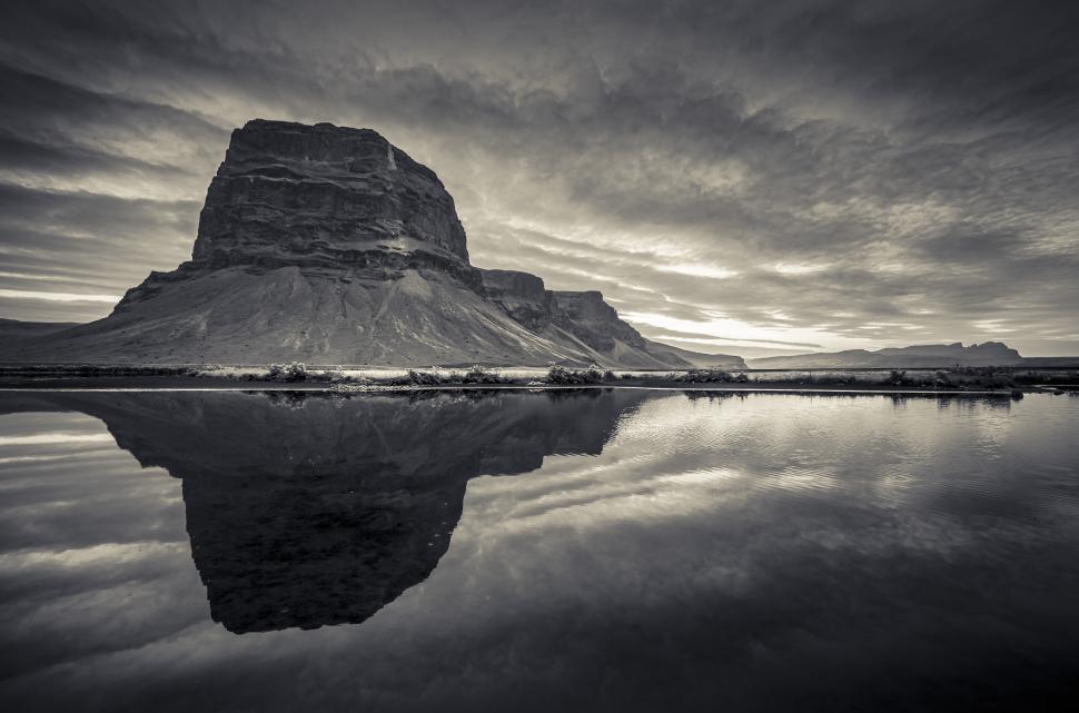 Free Image of A mountain next to a body of water 
