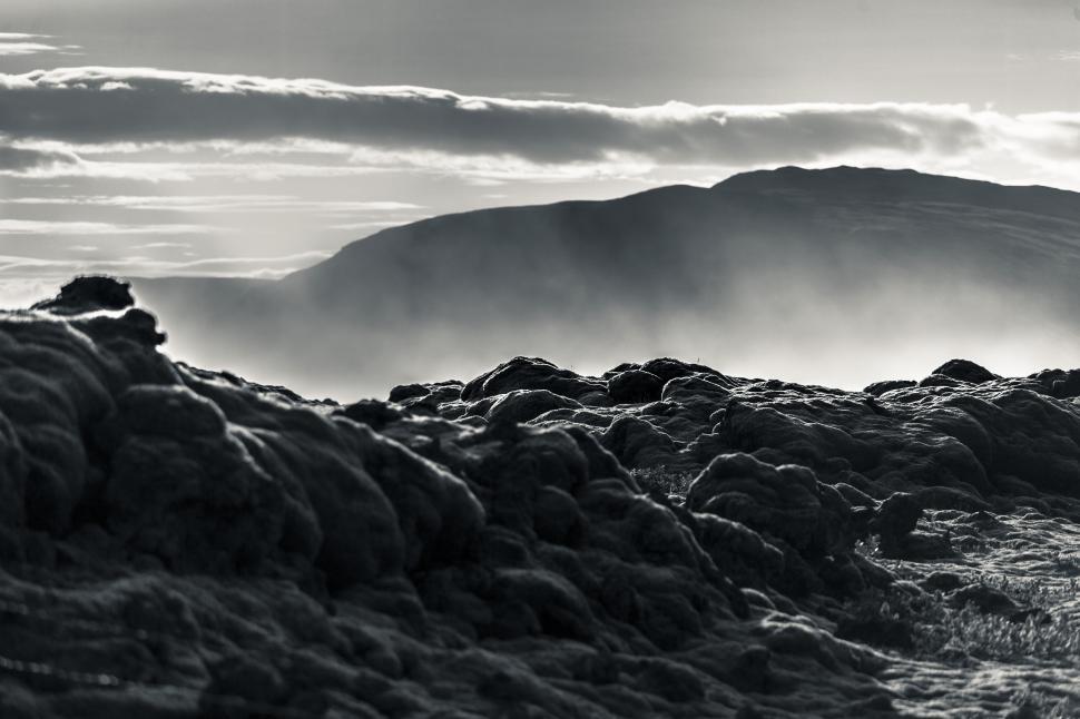 Free Image of A rocky landscape with mountains in the background 