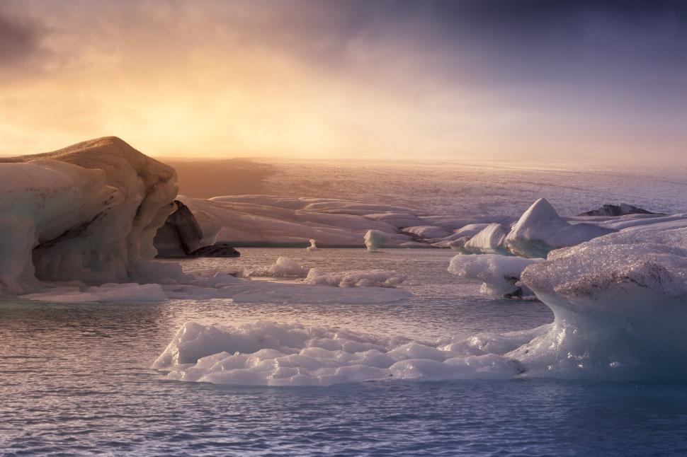 Free Image of Icebergs in the water with a cloudy sky 