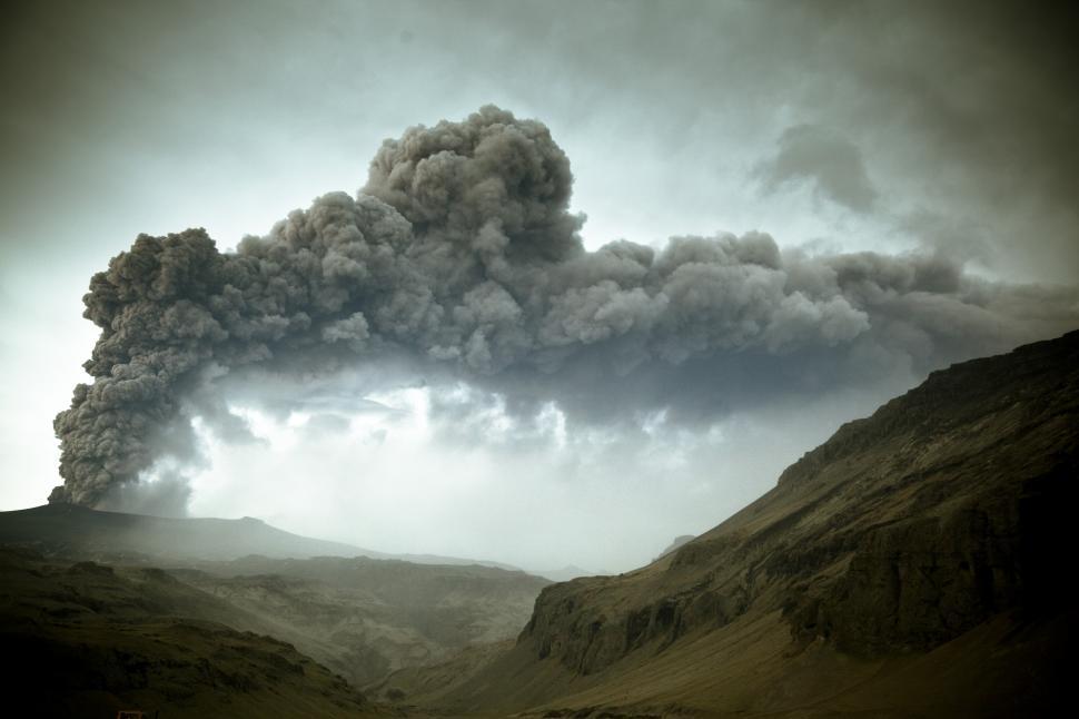 Free Image of A smoke billowing from a mountain 