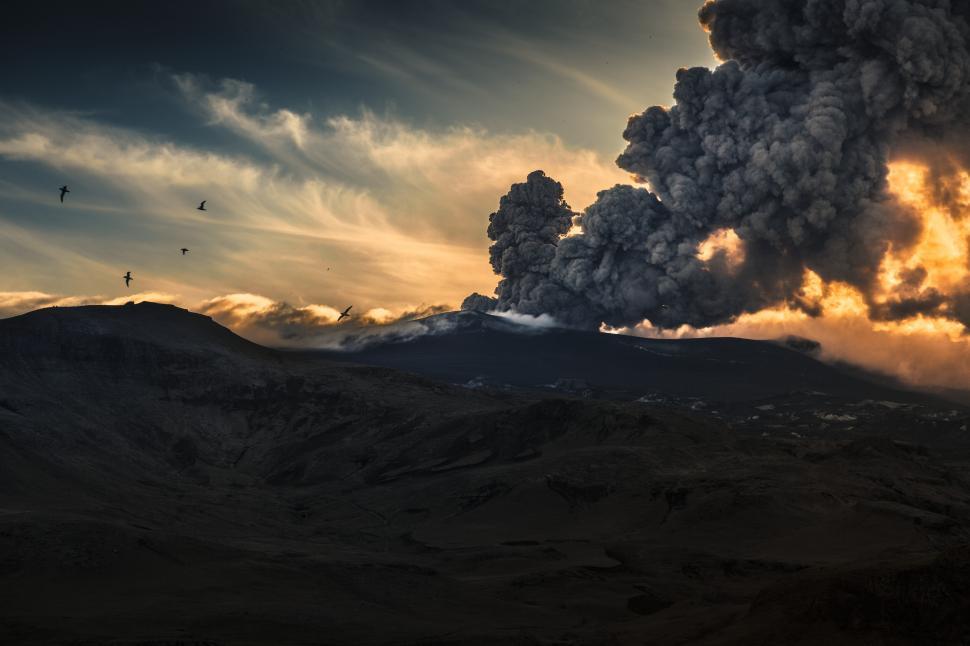 Free Image of A smoke billowing from a mountain 