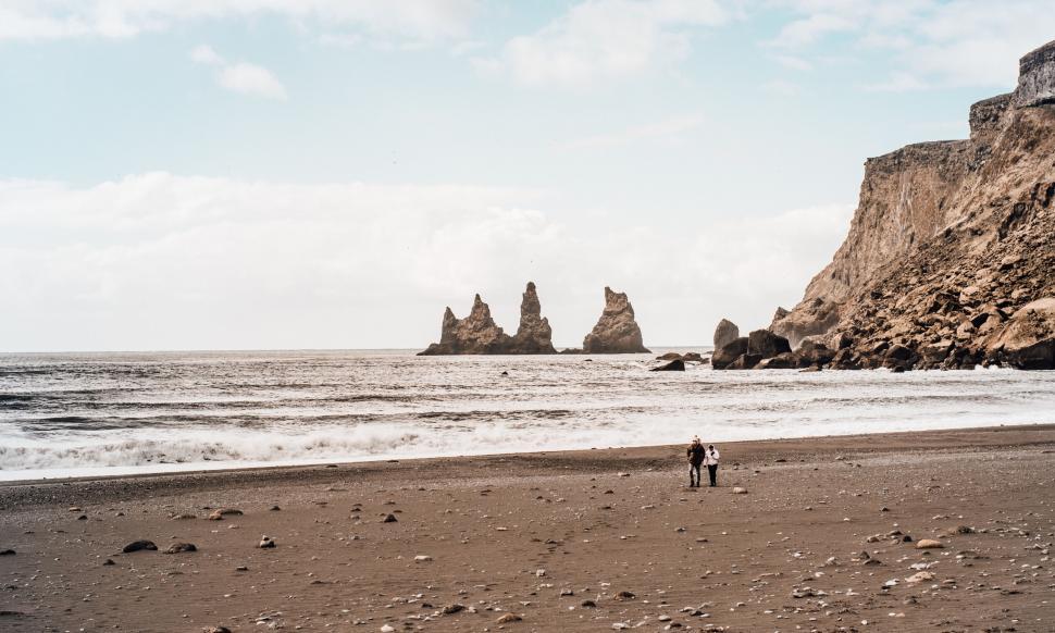 Free Image of People walking on a beach 
