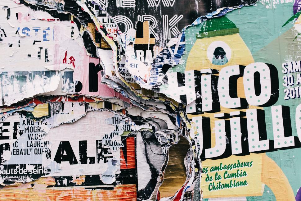 Free Image of A wall with torn posters 