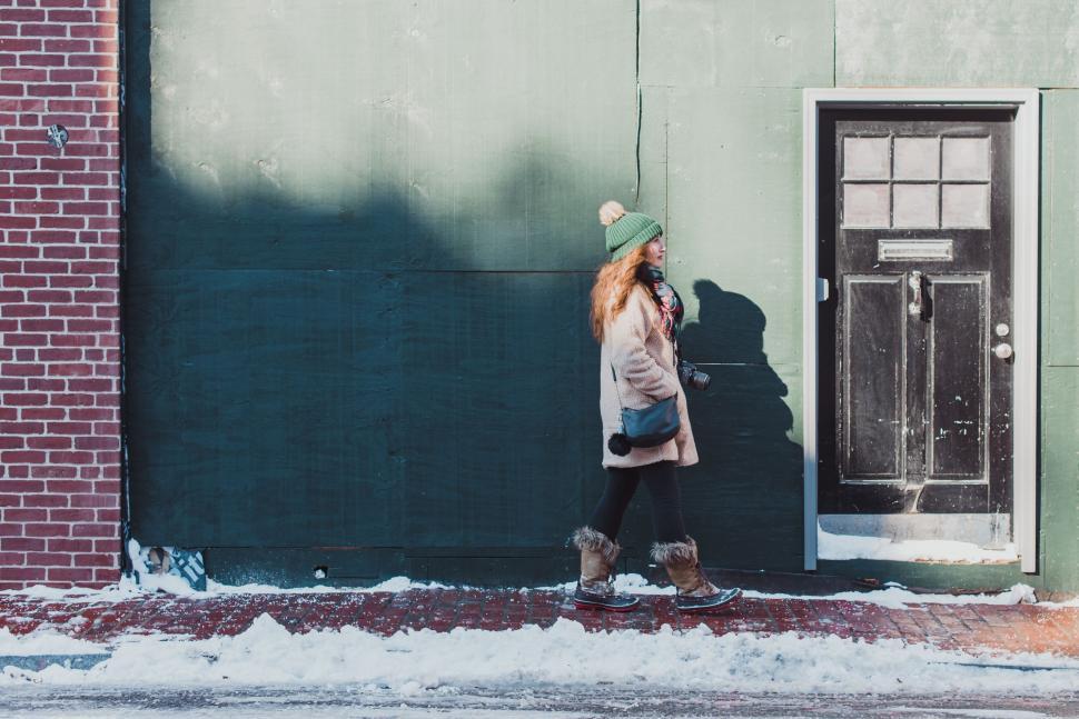 Free Image of A woman walking in the snow 