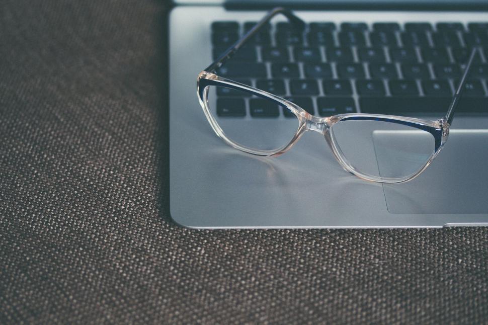 Free Image of A pair of glasses on a laptop 
