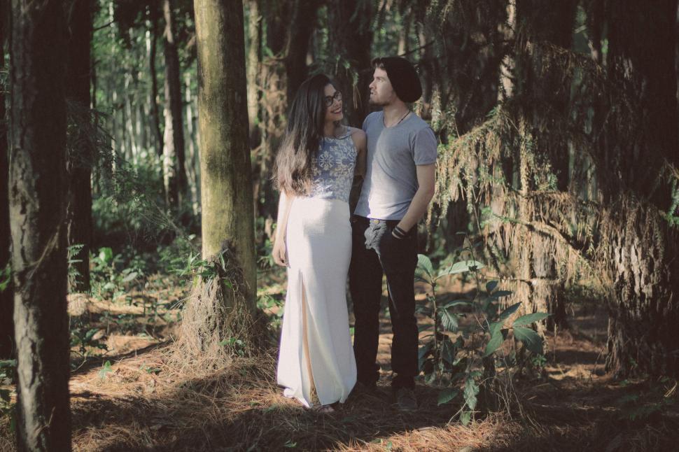 Free Image of A man and woman standing in the woods 