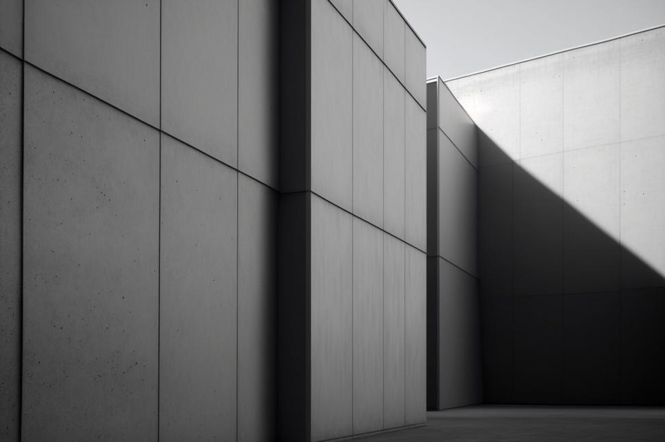 Free Image of A concrete wall with a shadow on the ground 