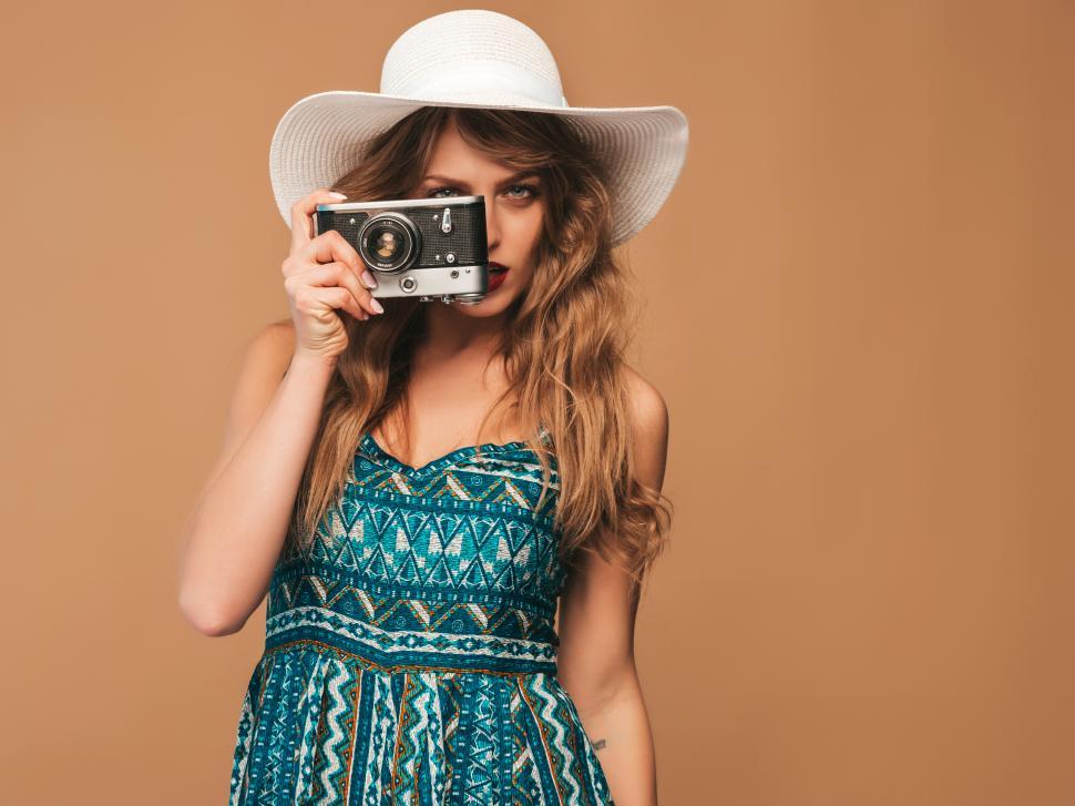 Free Image of A woman holding a camera upside down 