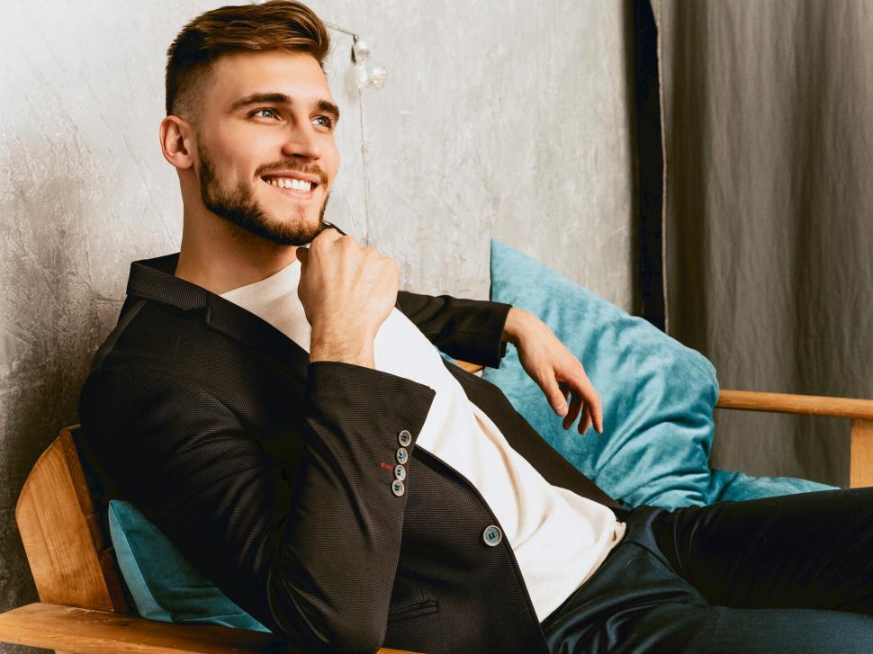 Free Image of A man sitting in a chair 