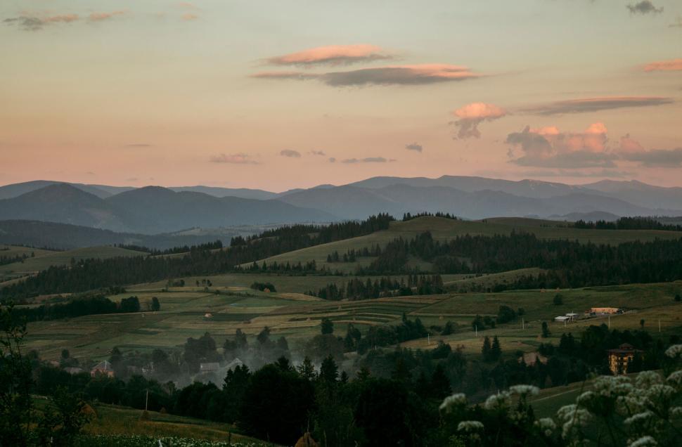 Free Image of A landscape of a valley with trees and mountains 