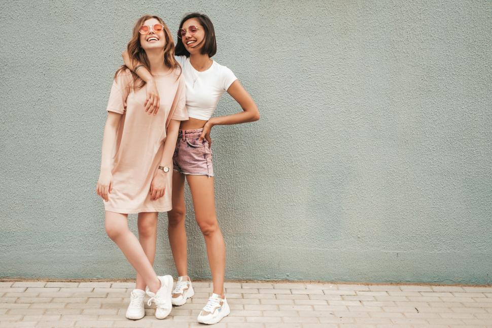 Free Image of Two women standing together smiling 