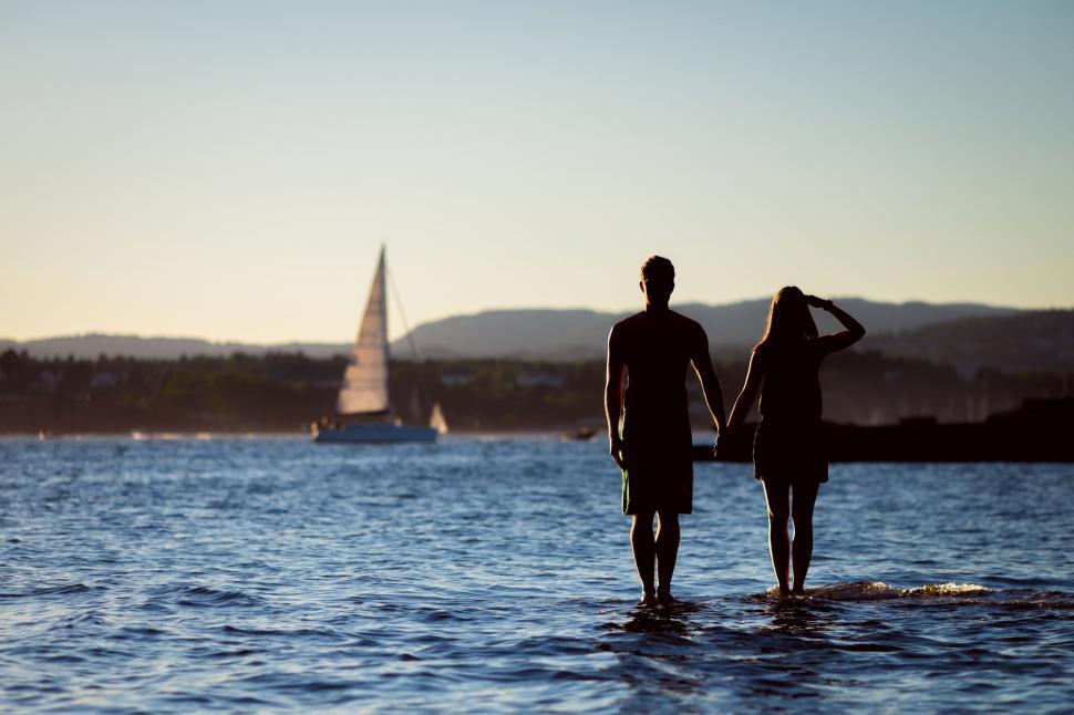 Free Image of A man and woman standing in water 