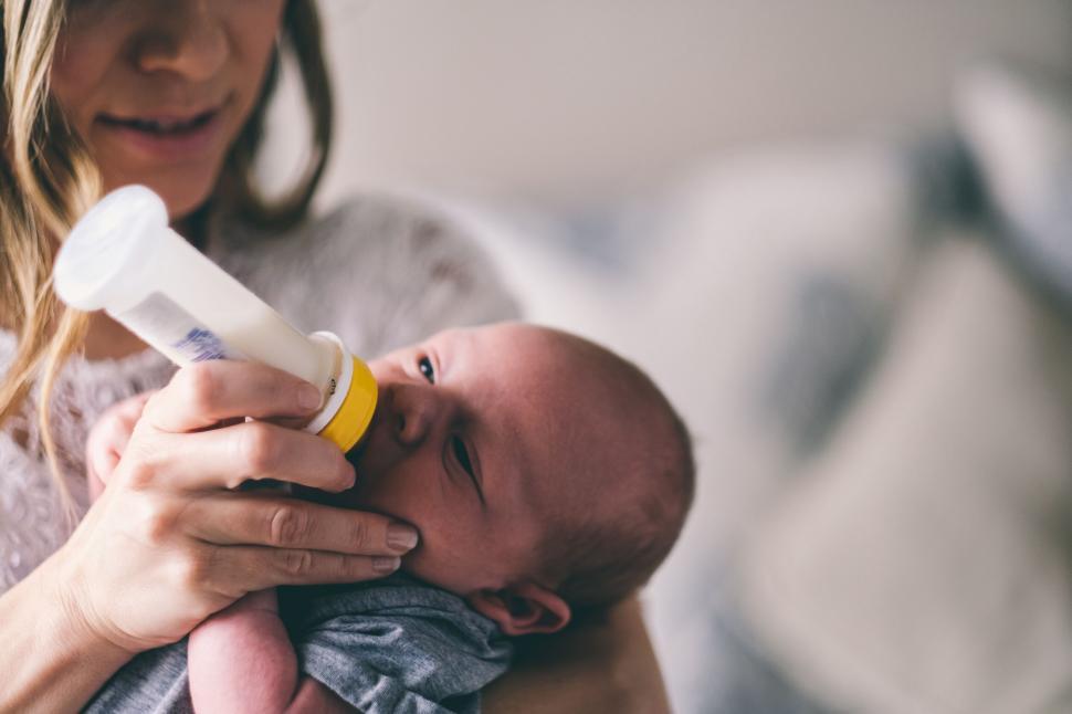 Free Image of A woman feeding a baby 