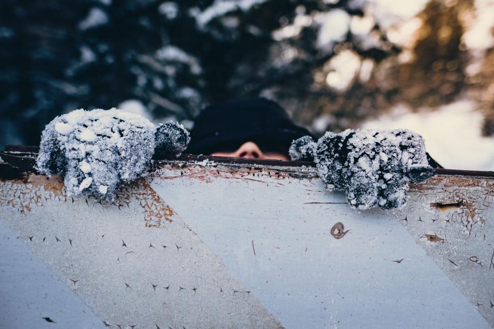 Free Image of A person holding a sign with snow on it 