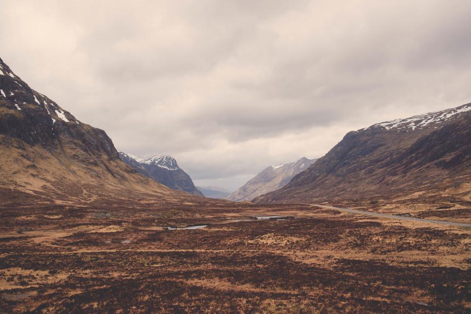 Free Image of A landscape of a valley with mountains and snow 