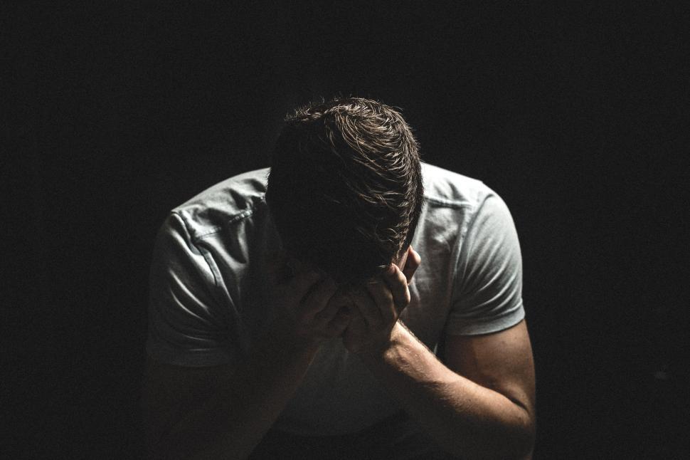 Free Image of A man with his hands in his face 