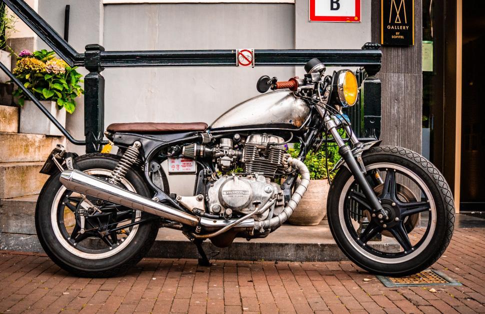 Free Image of A motorcycle parked on a brick sidewalk 