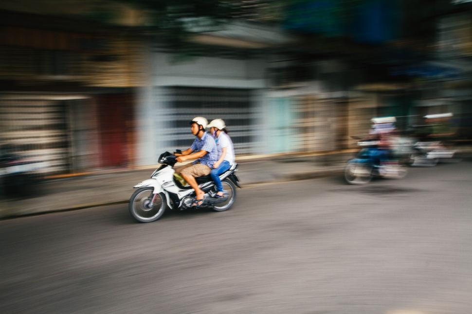 Free Image of A group of people riding a motorcycle 