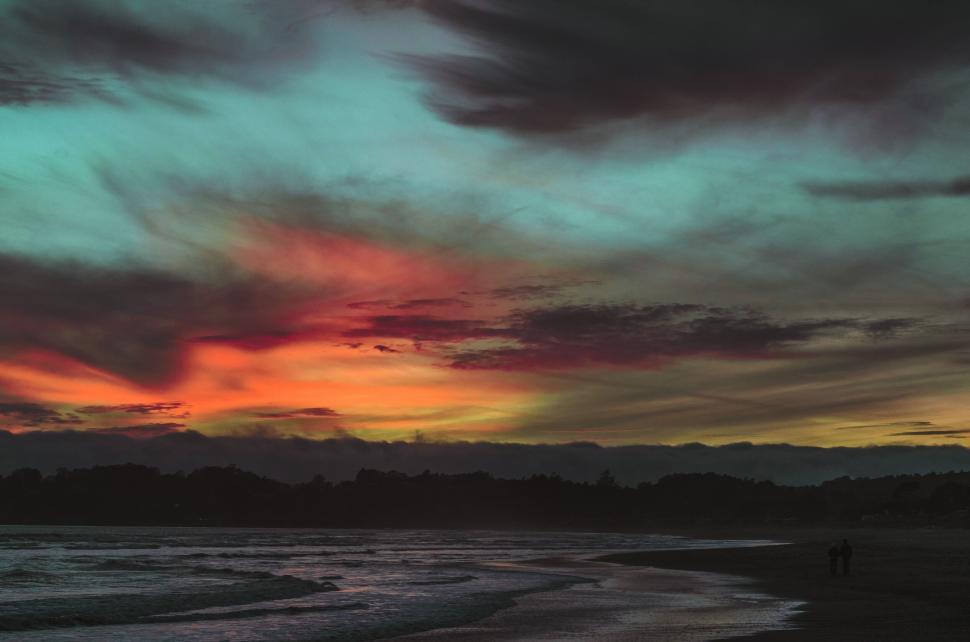 Free Image of A sunset over a beach 
