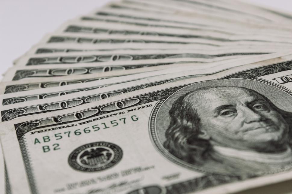 Free Image of A stack of money on a white surface 