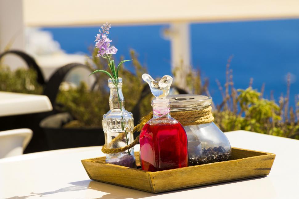 Free Image of A tray with bottles and flowers on it 