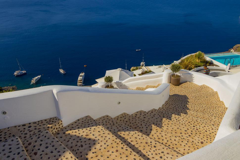Free Image of A stairs leading up to a body of water 