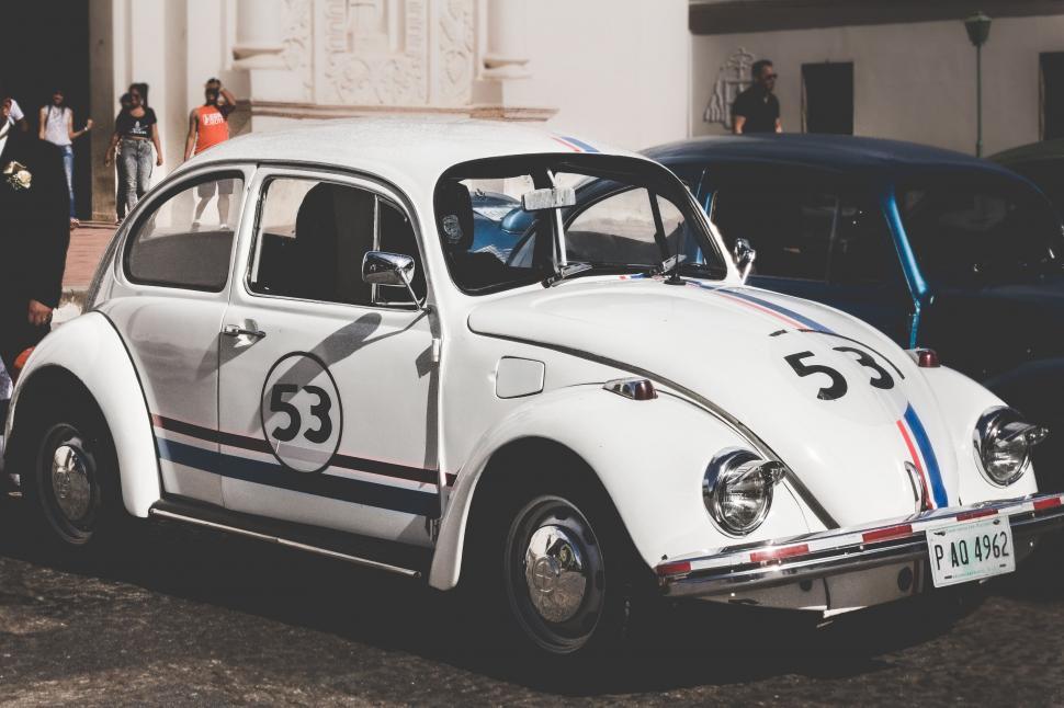 Free Image of A white car with a number on the front 