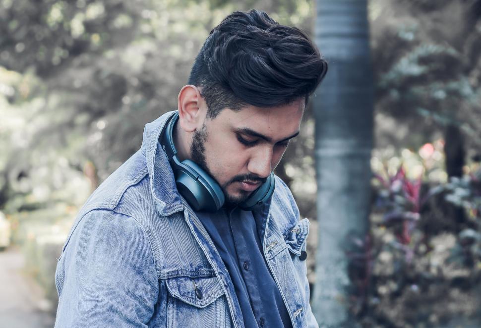 Free Image of A man with headphones on his neck 