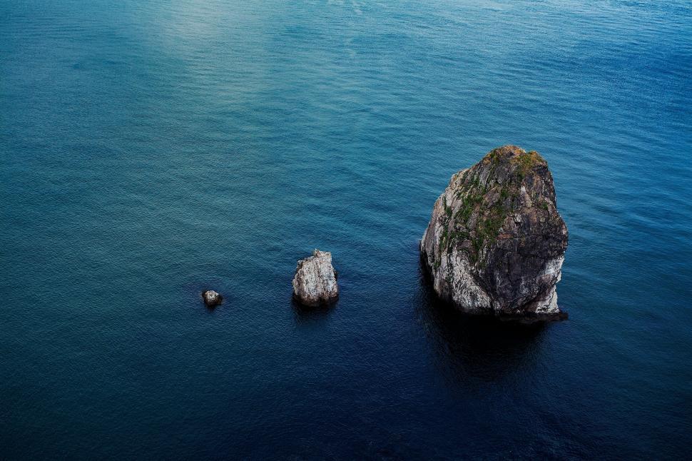 Free Image of A group of rocks in the water 