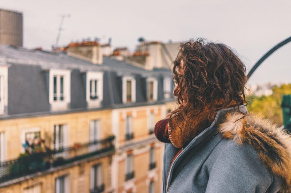 Free Image of A woman looking at a building 