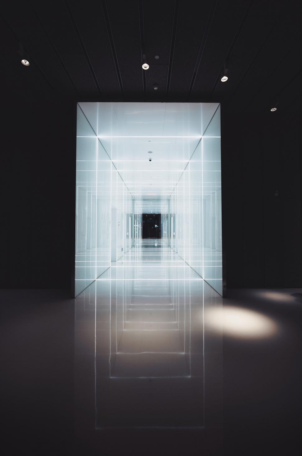 Free Image of A hallway with lights on the walls 