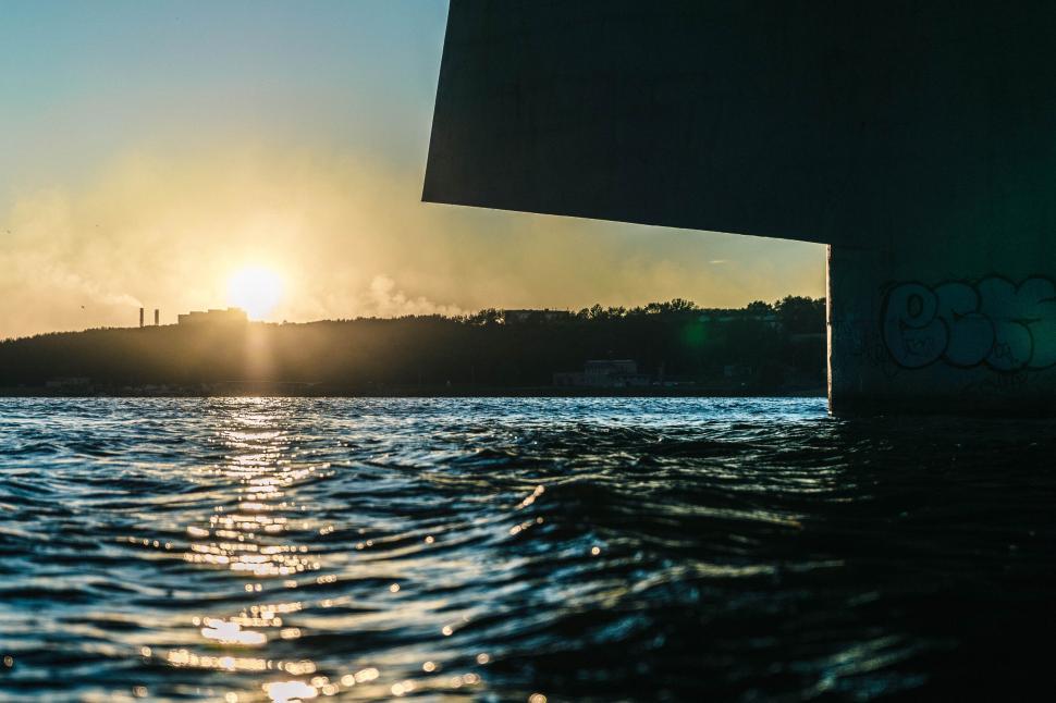 Free Image of A body of water with a bridge in the background 