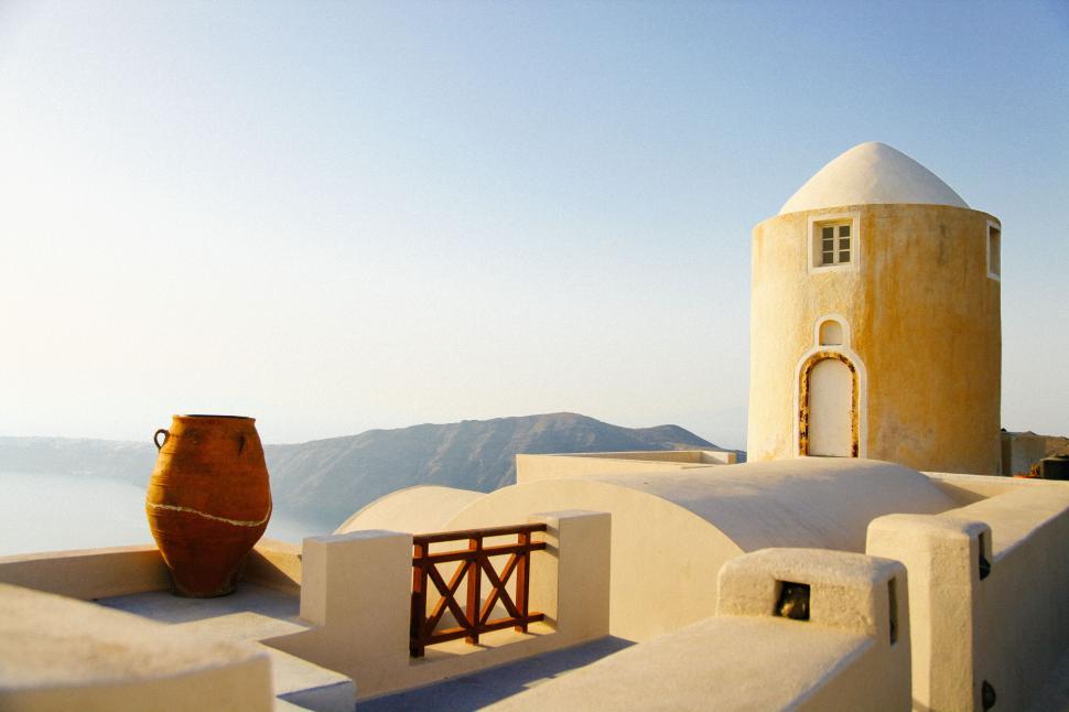Free Image of A building with a large pot on top of it 