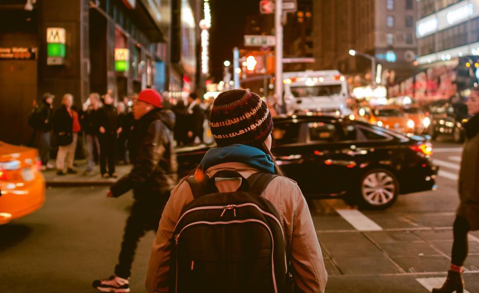 Free Image of A person standing on a sidewalk in a city 