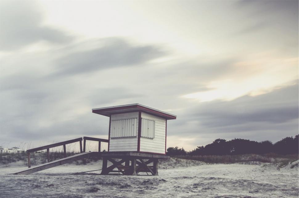 Free Image of A small white building on a wooden platform 